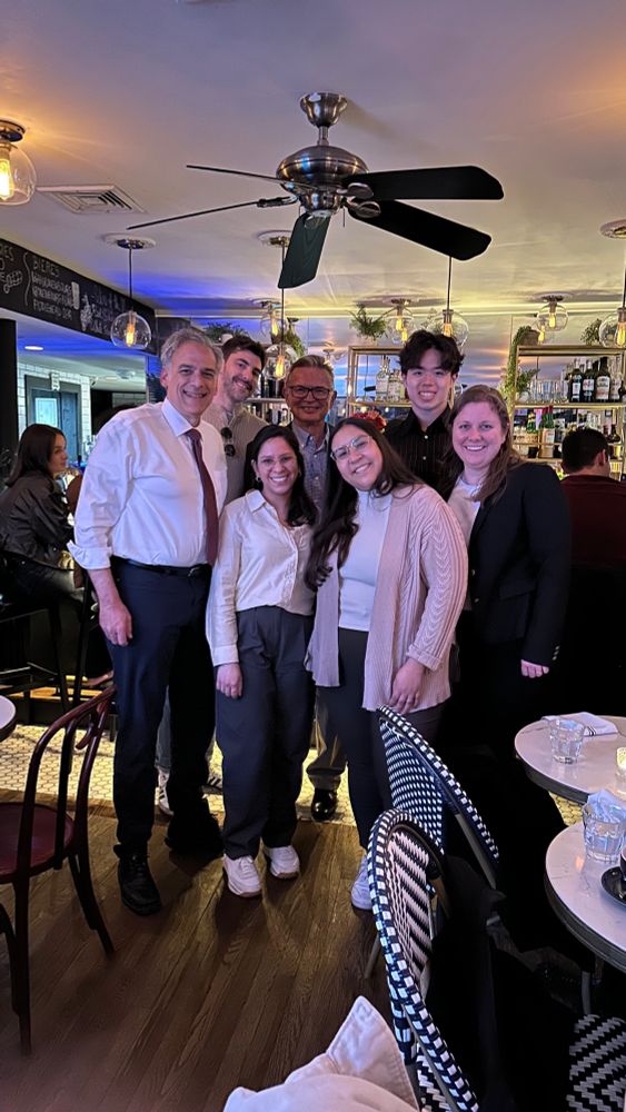 A group of 7 people at a restaurant. 