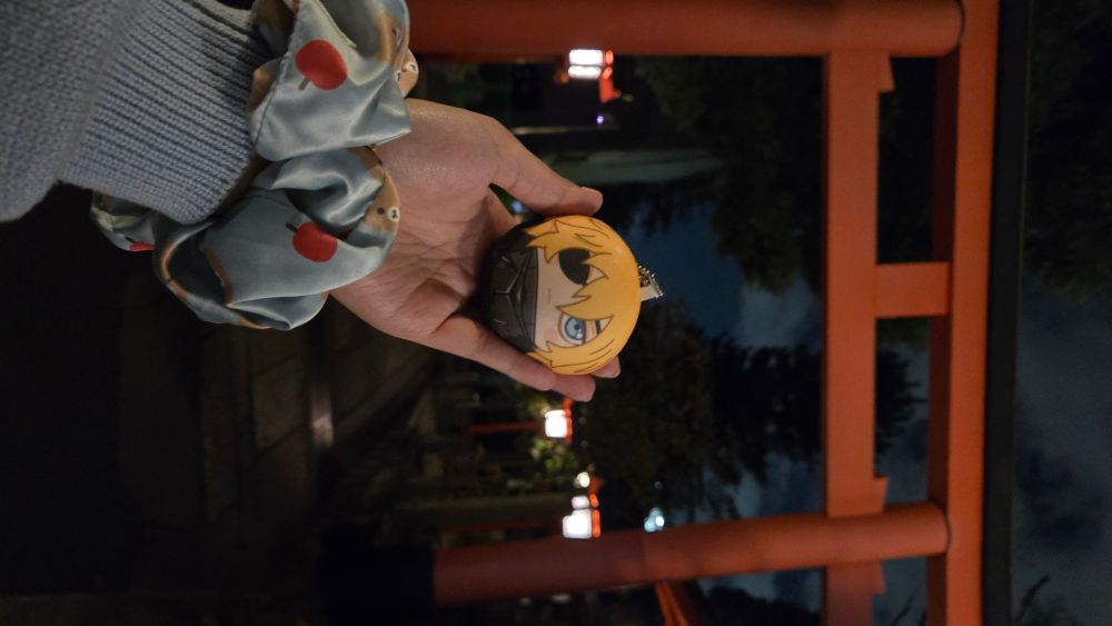 dimitri posed in front of a red torii shrine gate