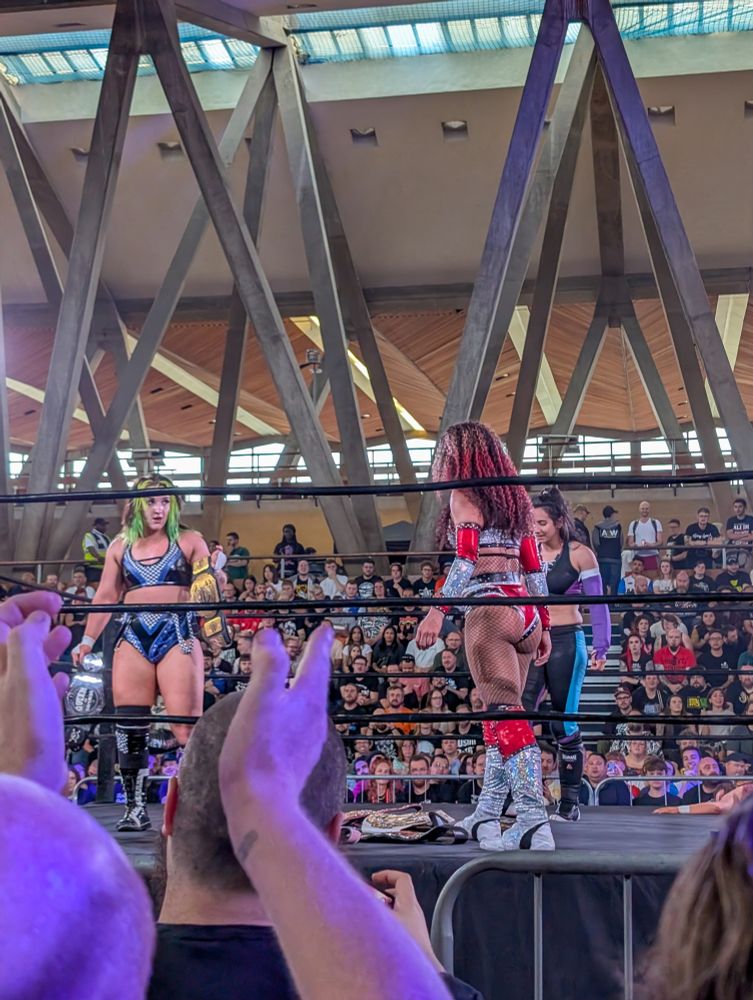 Dani Luna holds two of Mercedes Mone's title belts 