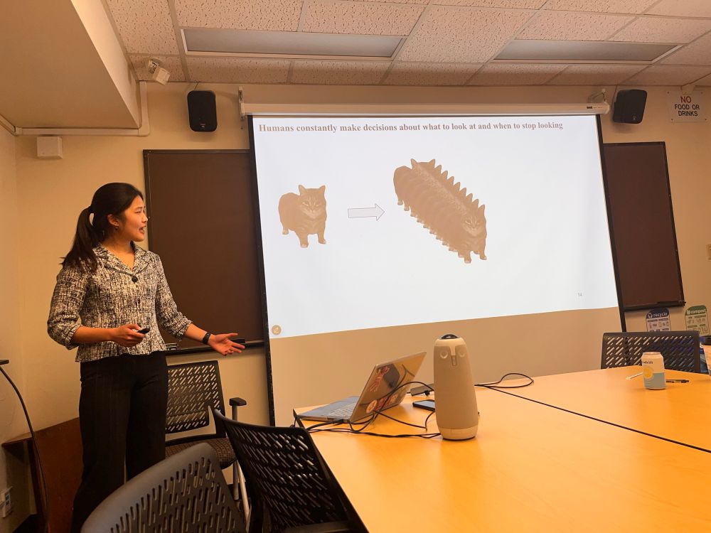 Anjie showing cat photos at her defense. 