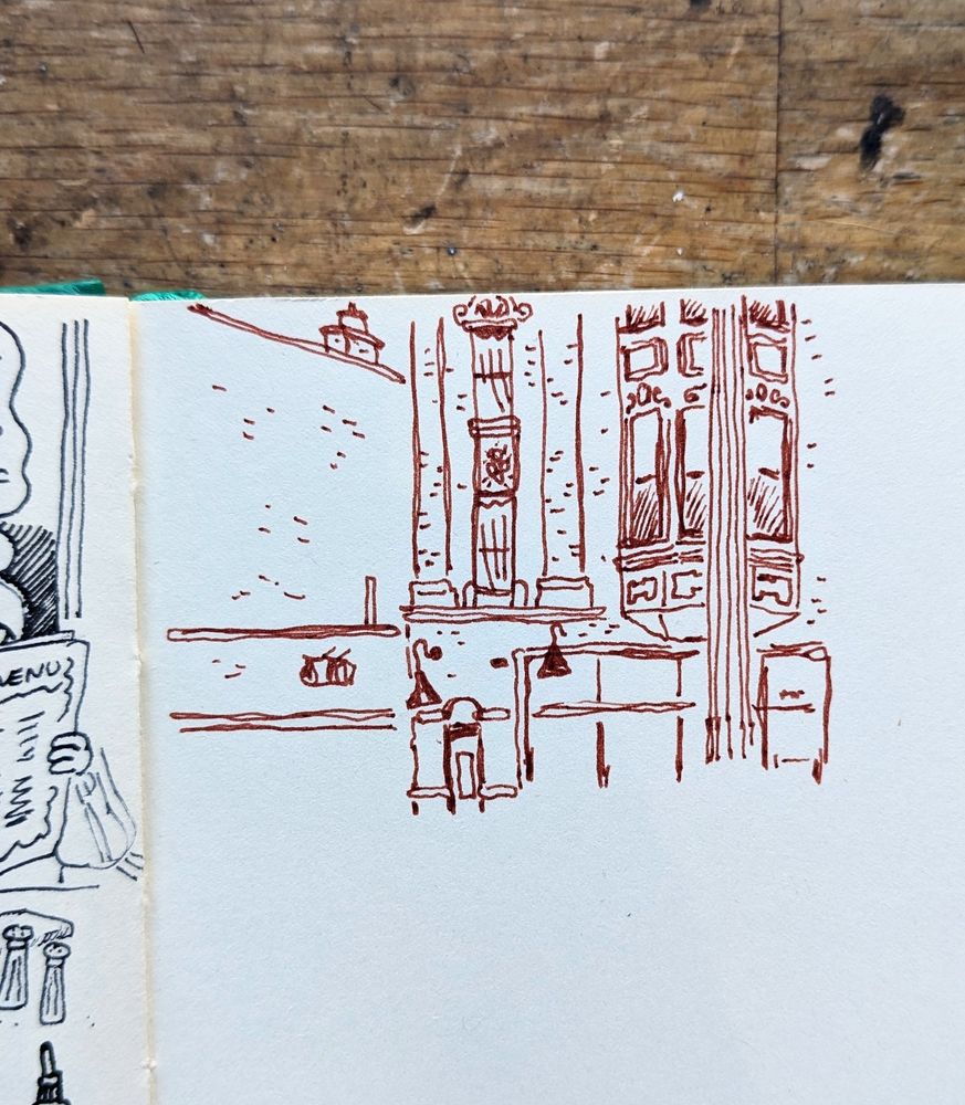 The view from wormhole coffee while sitting with Riley in the front window, the buildings across the street has a funky 1930's style decor next to new builds, all brick buildings, brown ink on paper