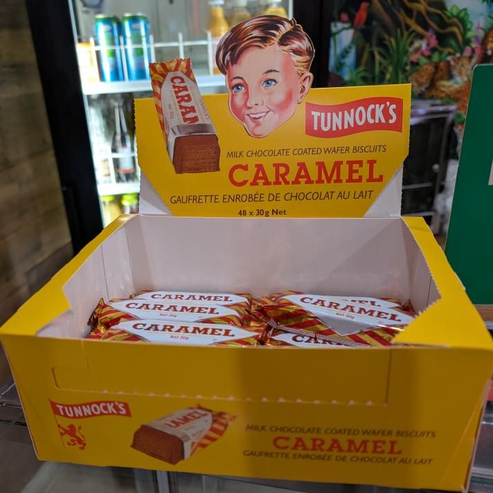 a yellow display box of Tunnock's Caramel Wafers sitting on the counter of Inner Circle, my local Guyanese restaurant