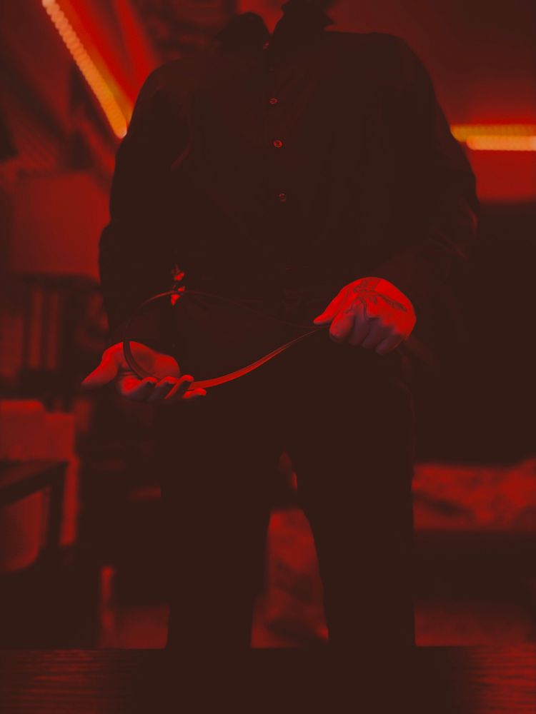 Spooky standing and waiting with a belt in his hands 