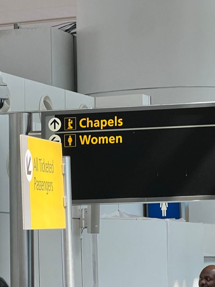 sign giving directions with the top/forward direction reading chapels and the second/sideways direction reading women