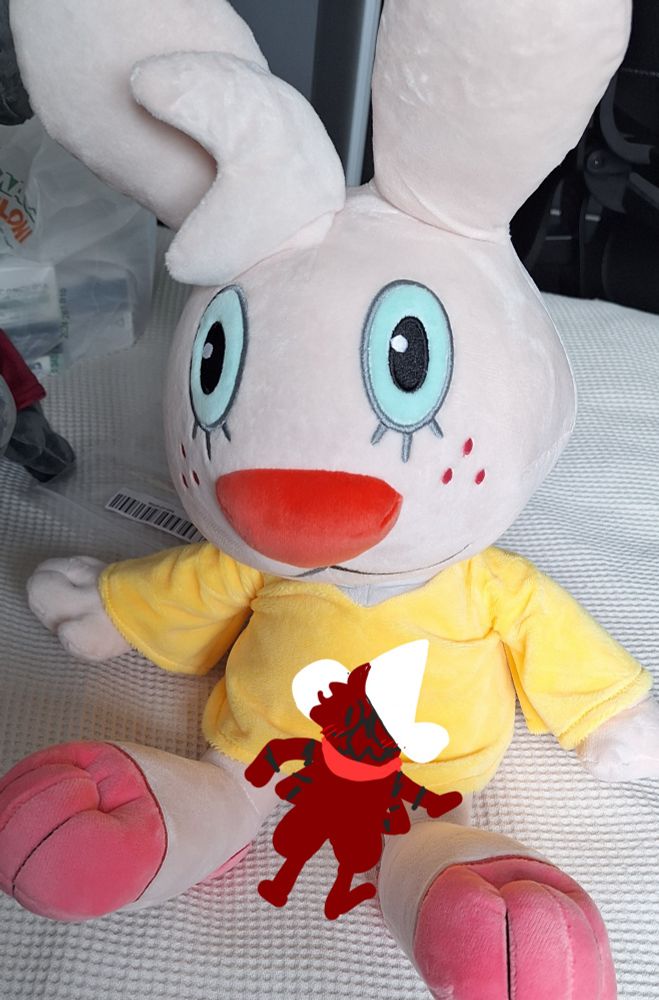 a plushie of angel gabby, from internet series "angel hare", with a the kobold poorly drawn sitting on her lap, using phone image editing
