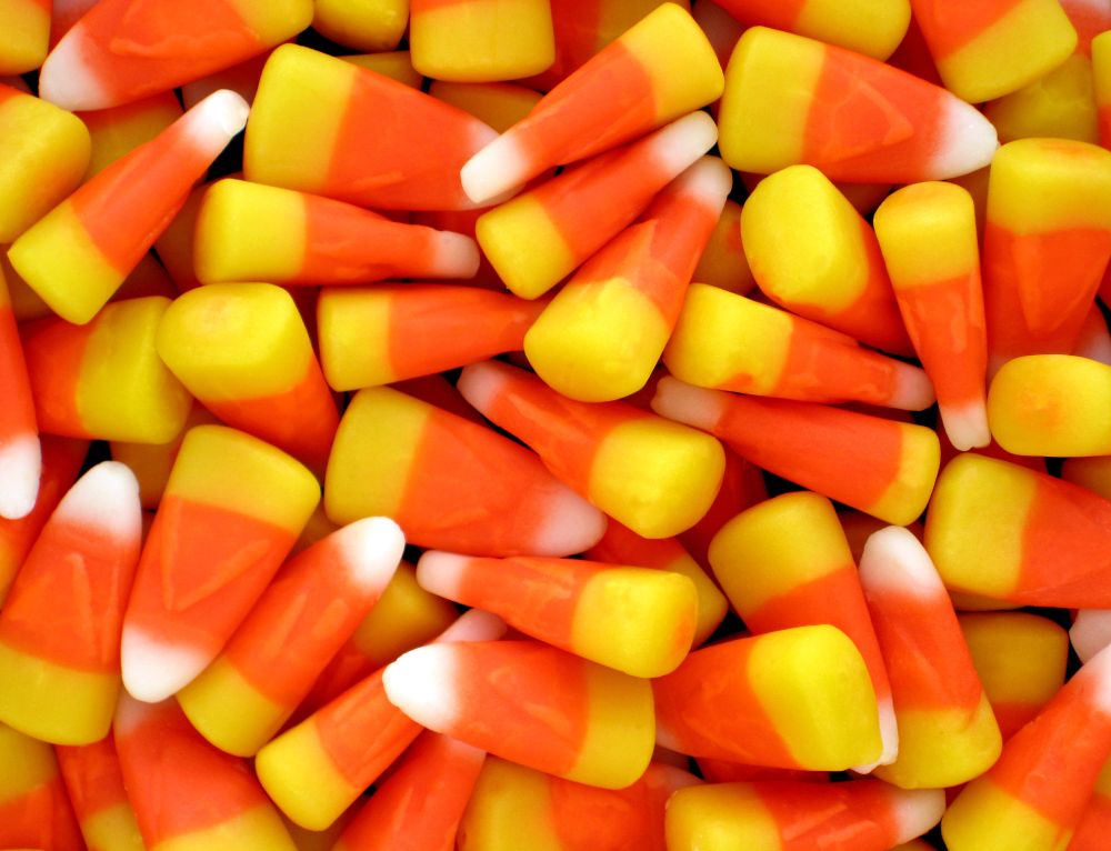 Candy corn pile. Triangles with yellow base, red middle, white tip.