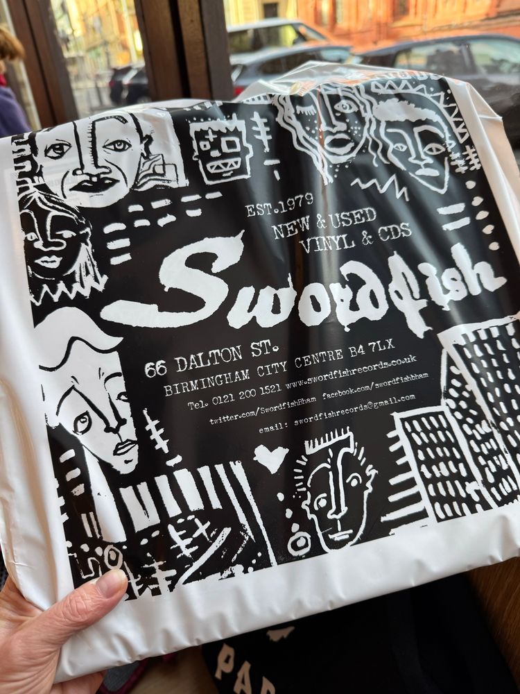 A black and white record store bag. The text reads “Est. 1979. New & used vinyl and CDs. Swordfish, 66 Dalton Street, Birmingham”