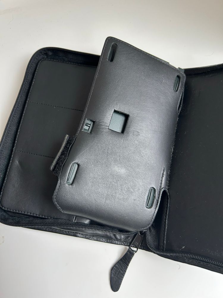 the back of the holster, which gives you access to the switch that locks the PCMCIA card slot on the messagepad-- AGAIN allowing you to use the device without ever removing it!