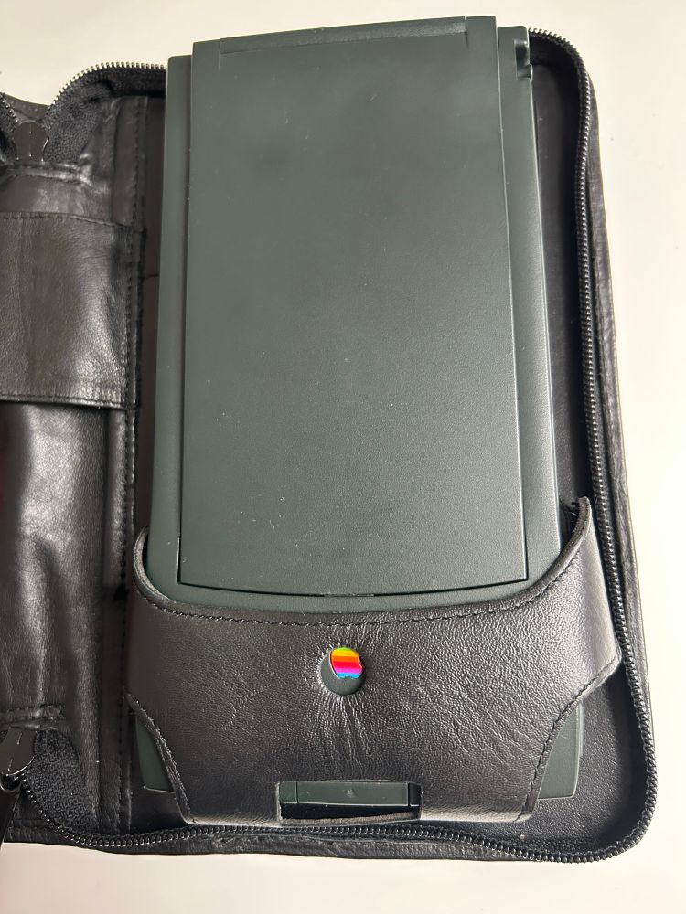 the newton messagepad 120 in its case's holster. the front of the holster ((a little oddly)) resembles crotchless underwear.. this is so you can depress the button that flips up the newtons cover without removing it from the case!!

peep the cutout so the apple logo on the device shows through!! fucken nerds