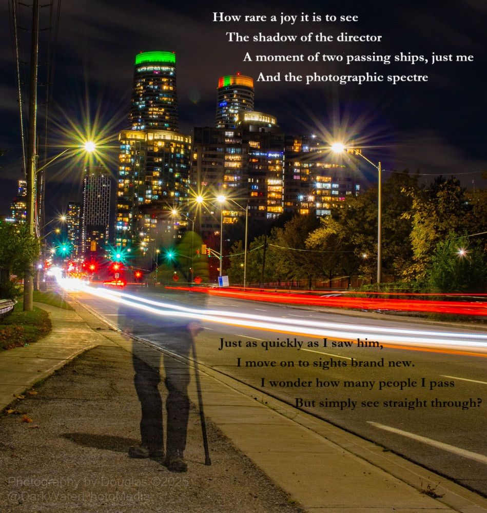 How rare a joy it is to see
The shadow of the director
A moment of two passing ships, just me
And the photographic spectre

Just as quickly as I saw him,
I move on to sights brand new.
I wonder how many people I pass
But simply see straight through?