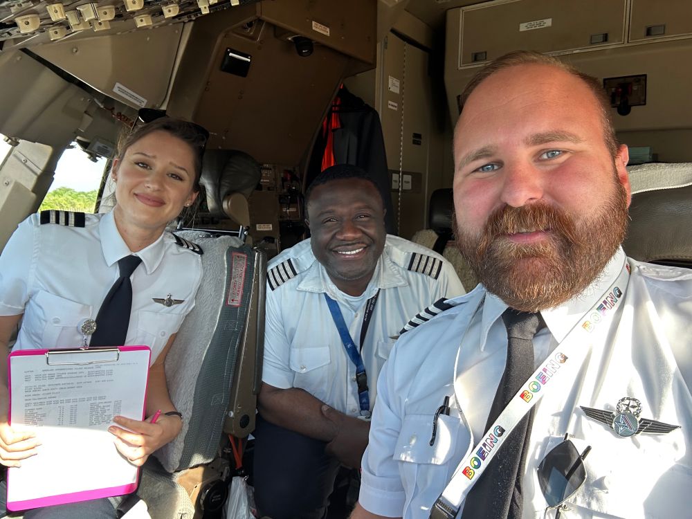 A diverse flight crew of a gay guy, a Black man, and a woman