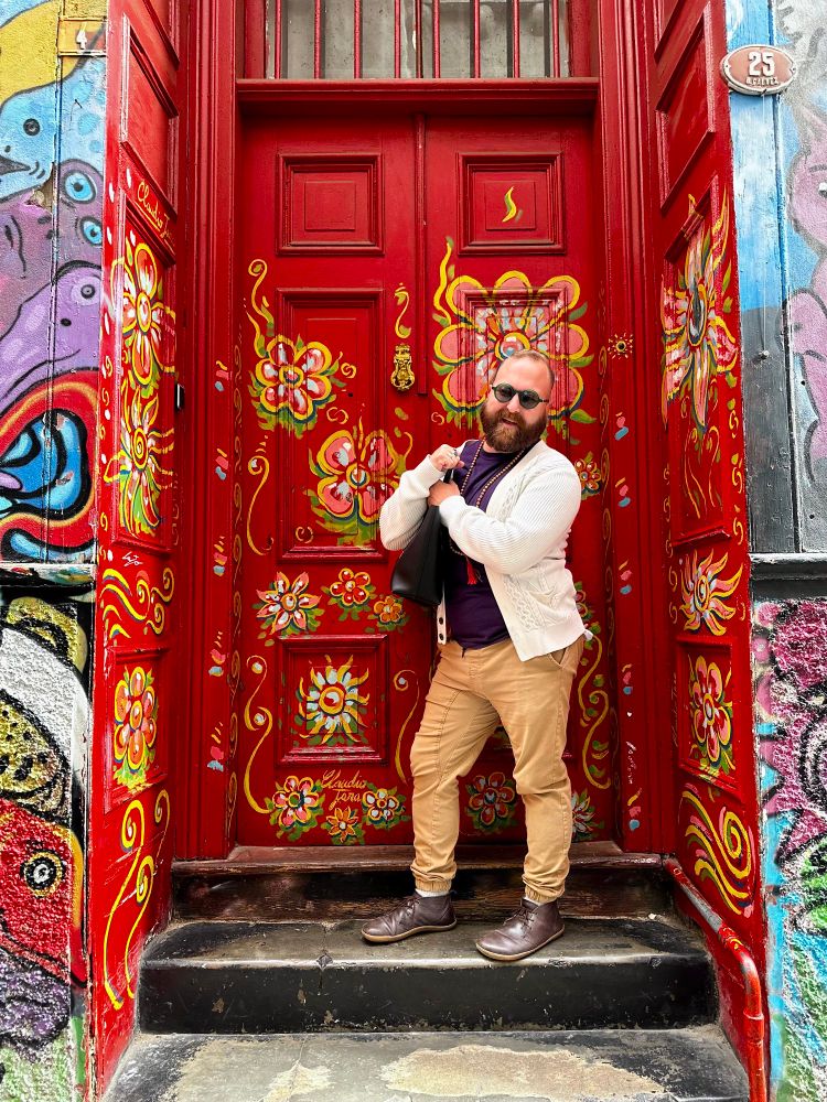 Bearded homosexual in a colorful doorway of Valpo, Chile