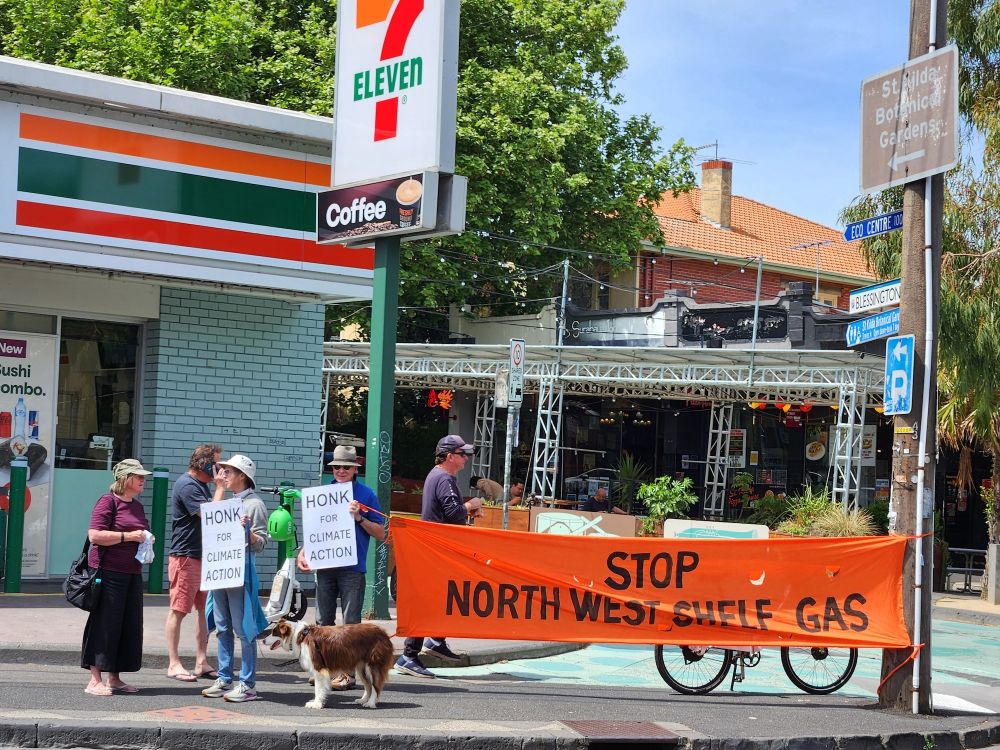 Protestors holding banners & placards across the road from the allegedly pro-environment Labor MP Josh Burns' office
The orange banner says STOP NORTH WEST SHELF GAS
Placards say HONK FOR CLIMATE ACTION (did they ever!)
A lovely brown & white dog rounds out the protest against Josh Burns' all talk no action, zero climate & environment achievement record