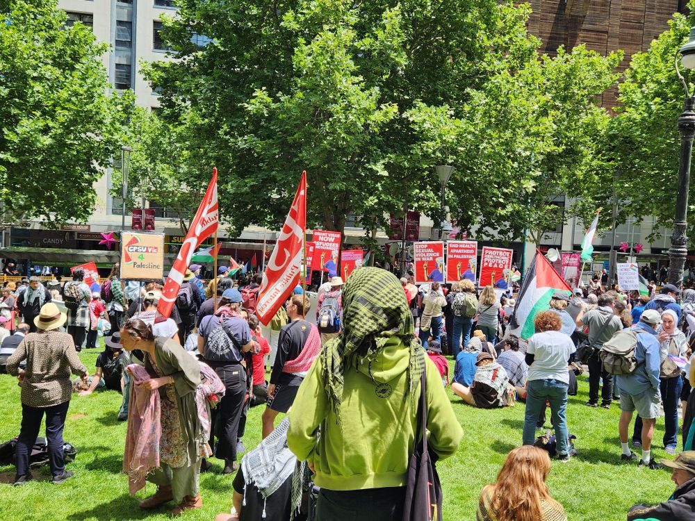 Anti-genocide protestors gathered on the lush, green lawns of the Victorian State Library on a bright, summer day