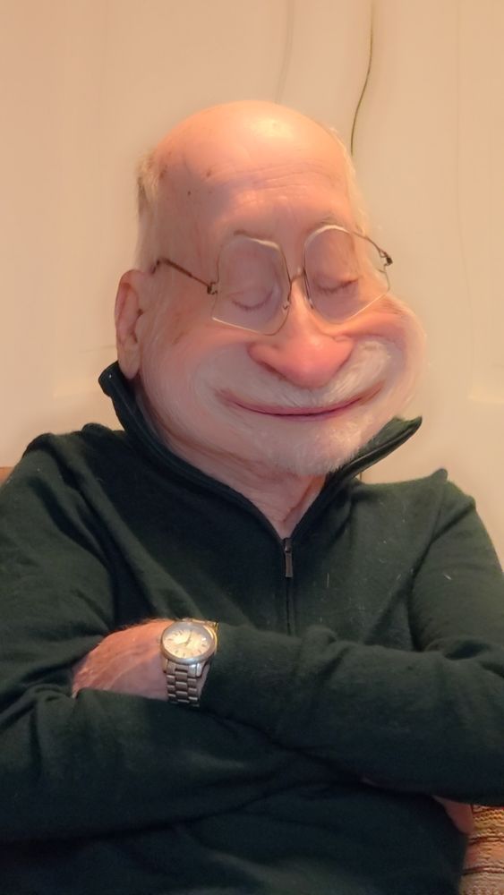 Elderly man with cartoonish face due to Snapchat filter. Lower half of the face is enlarged with chubby cheeks