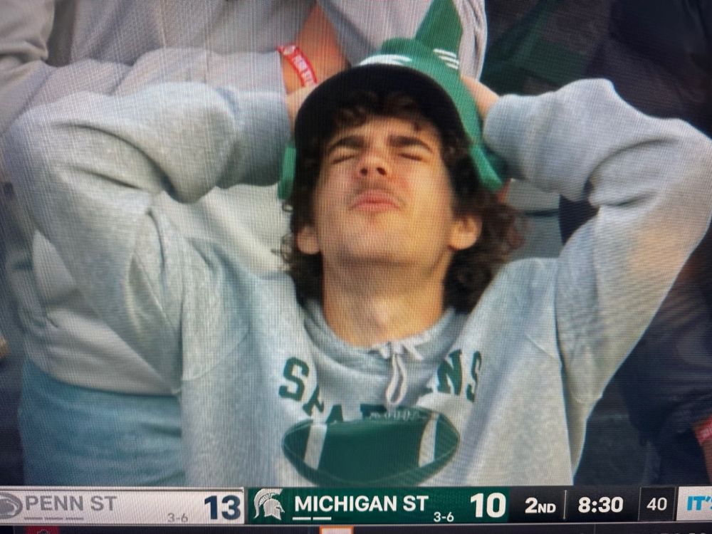 an anguished michigan state fan reacting to a 75-yard penn state touchdown pass