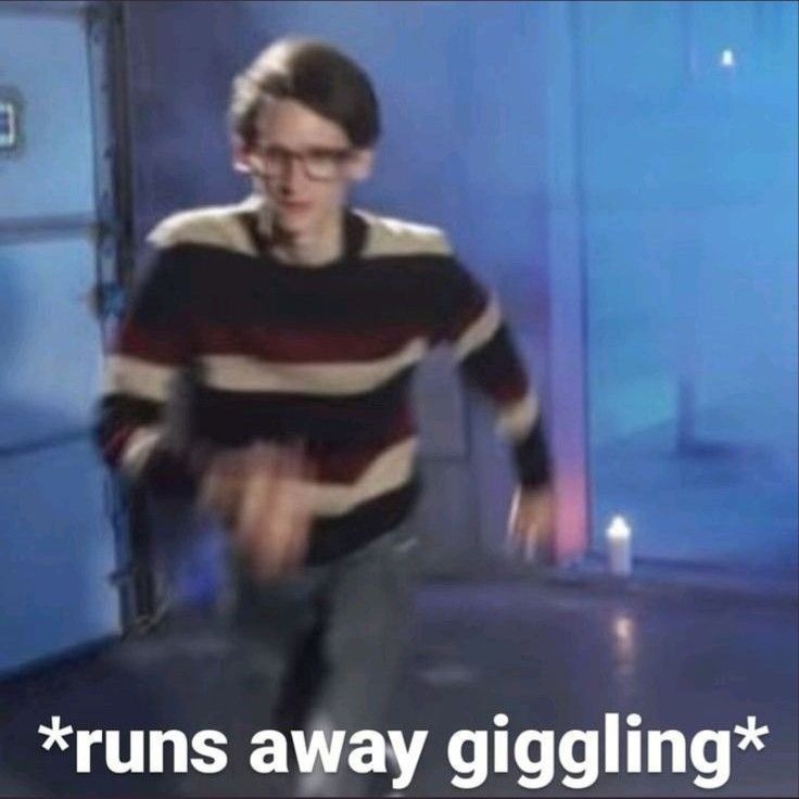 a blurry photo of neil cicierega running with the caption "*runs away giggling*"