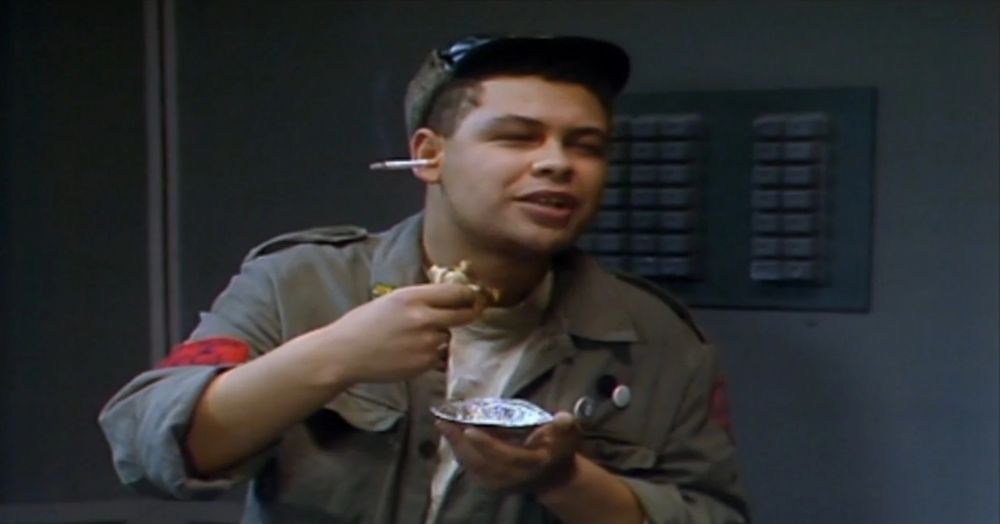 Dave Lister from Red Dwarf eating curry with a lit cigarette in his ear