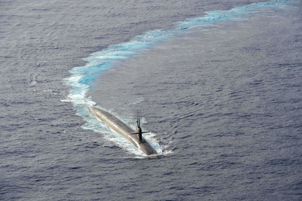 The Ohio-class ballistic-missile submarine USS Kentucky (SSBN 737) maneuvers during a routine armed air escort exercise, April 24, 2025. The U.S. Navy’s fleet of ballistic missile submarines are the most survivable leg of the nuclear triad. Global SSBN operations demonstrate the flexibility, survivability, readiness, resolve, global reach and capability of the U.S. SSBN force. Commander, Submarine Group (SUBGRU) 9, exercises administrative control authority for assigned submarine commands and units in the Pacific Northwest providing oversight for shipboard training, personnel, supply and material readiness of submarines and their crews. SUBGRU-9 is also responsible for nuclear submarines undergoing conversion or overhaul at Puget Sound Naval Shipyard in Bremerton, Washington. (U.S. Navy photo by Mass Communication Specialist 1st Class Ryan Riley)