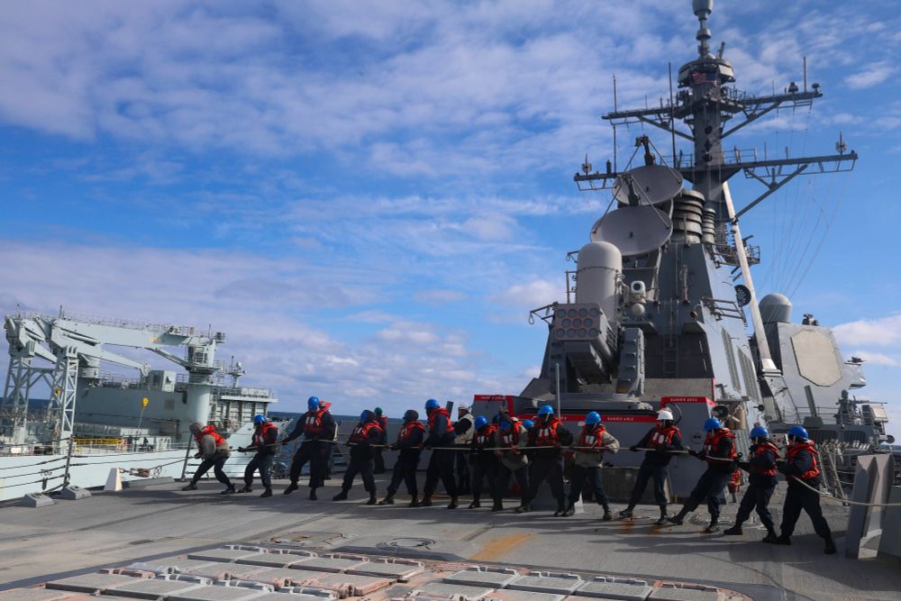 NORWEGIAN SEA – (May 05, 2025) U.S. Navy Sailors assigned to the Arleigh Burke-class guided-missile destroyer USS Bulkeley (DDG 84), heave in the phone and distance (P&D) line from the Royal Canadian Navy replenishment oiler MV Asterix for an underway replenishment during At-Sea Demonstration (ASD) / Formidable Shield (FS) 2025. ASD/FS 25 is the largest at-sea live-fire exercise in the European theater, hosted by U.S. 6th Fleet and executed by Naval Striking and Support Forces NATO. ASD/FS 25 is designed to enhance Allied interoperability in a joint, live-fire, Integrated Air and Missile Defense environment using NATO command and control reporting structures. (U.S. Navy photo by Mass Communication Specialist 2nd Class Jonathan Nye)