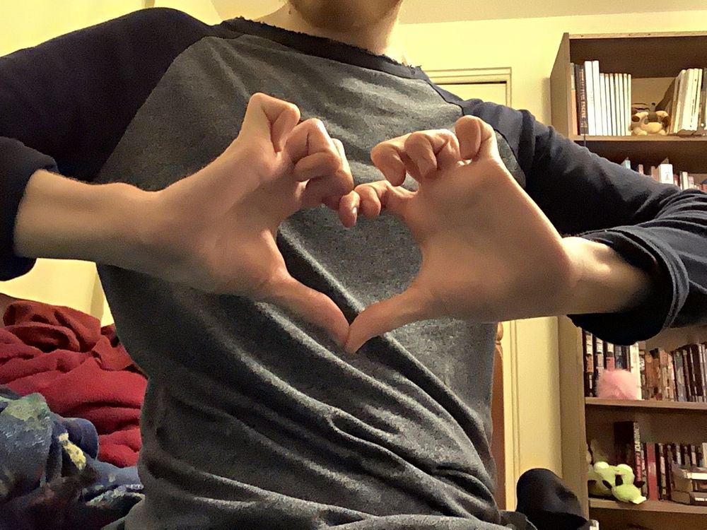 Two hands making a heart sign