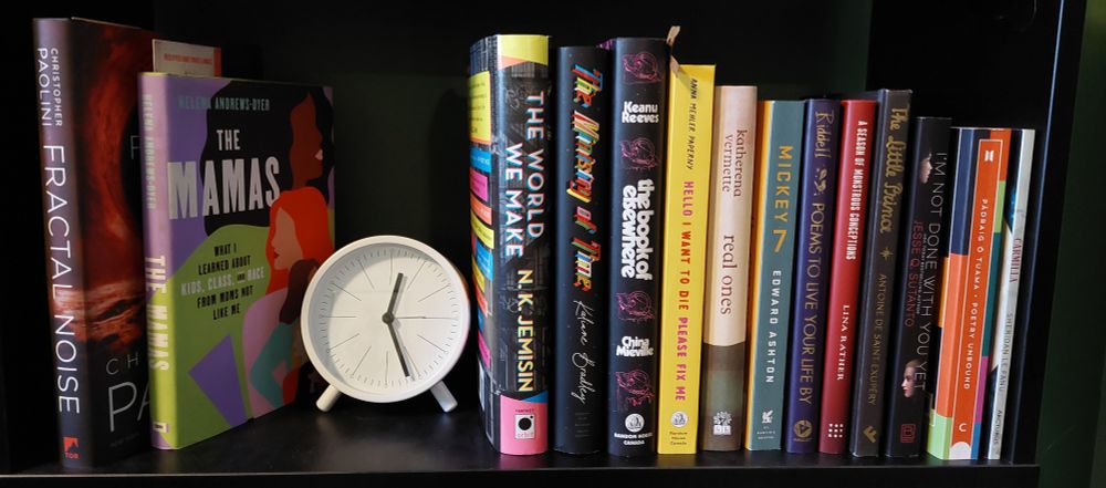 Books on the left: 
Fractal noise, the mamas.

Books on the right:
The world we make 
the ministry of time
the book of elsewhere
Hello I want to die Please fix me
 real ones
Mickey 7
 poems to live your life by
 a season of monstrous conceptions
The little Prince
 I'm not done with you yet
Poetry unbound
Carmilla.