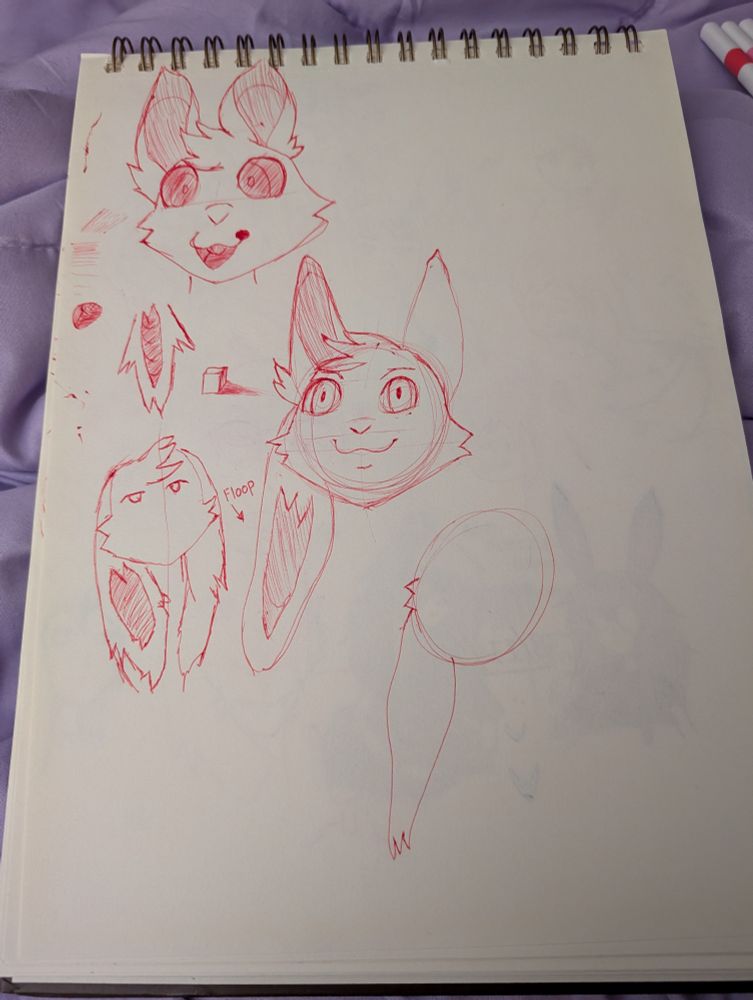 Sketch book drawings of anthro bunnies and people, among various other non-descript doodles