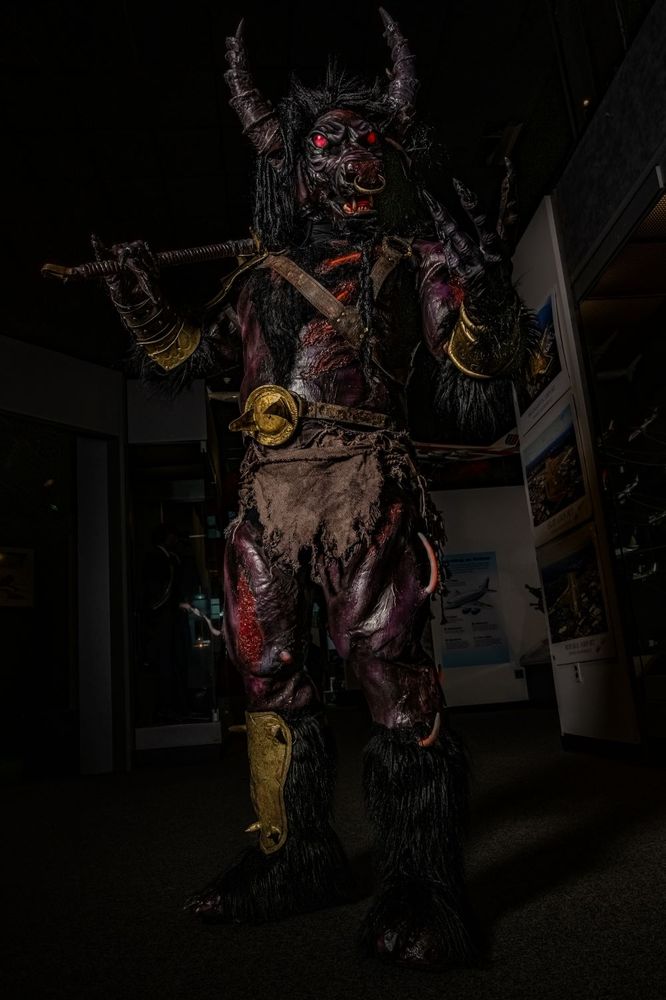 A minotaur cosplay in a dark corridor of a museum.