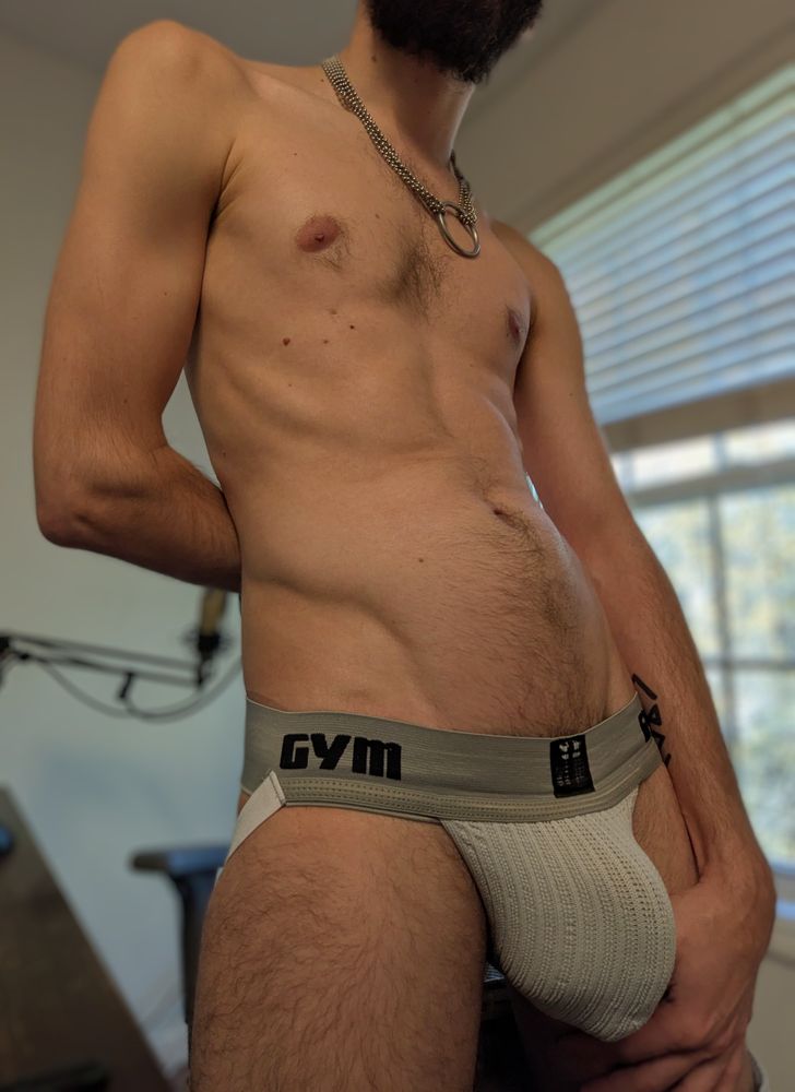 Thighs-up photo of me in a white jockstrap.