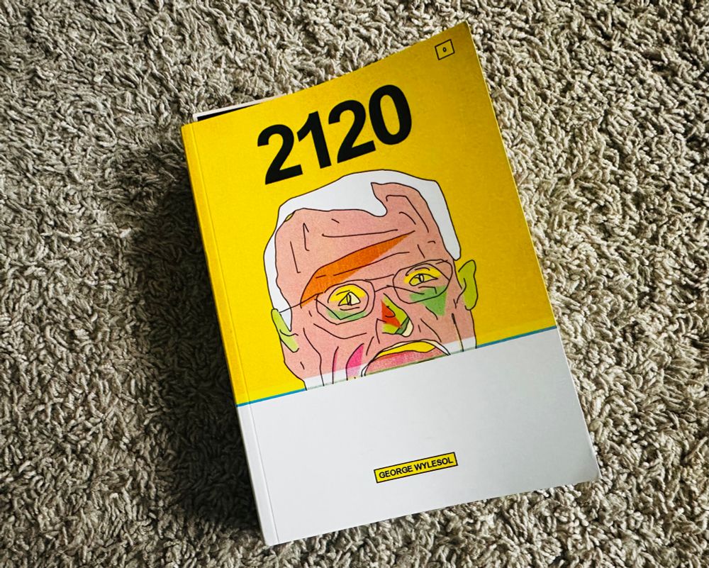 A book atop carpeting. Its cover is yellow with a man's scared face on it. Its title is 2120 and it is written by George Wylesol. 