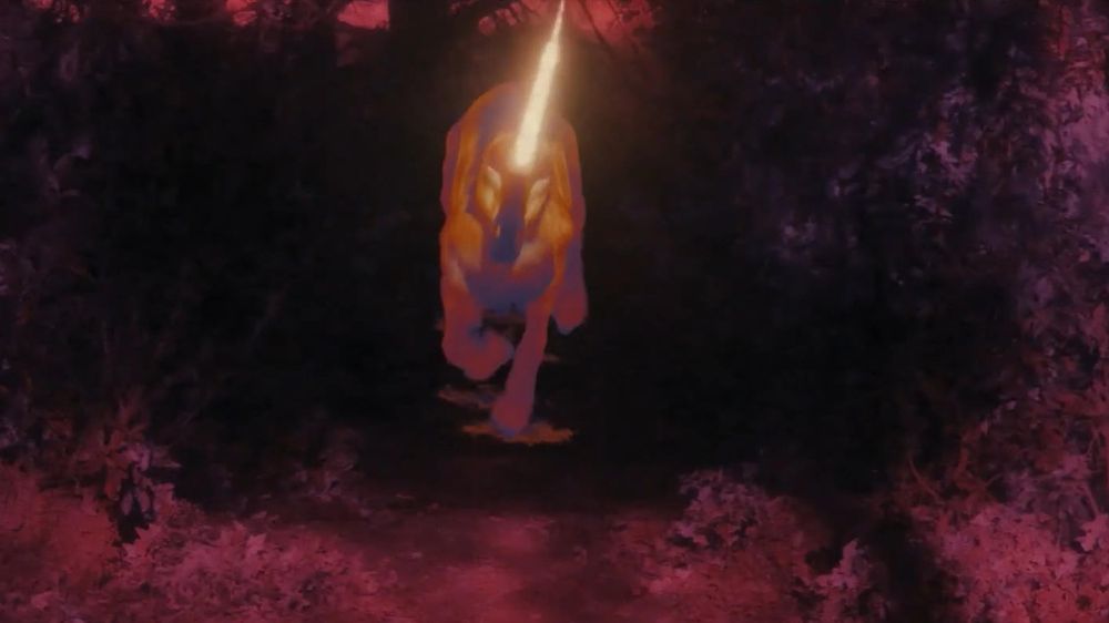 An infrared image of a charging unicorn coming straight towards the viewer, its horn ablaze.