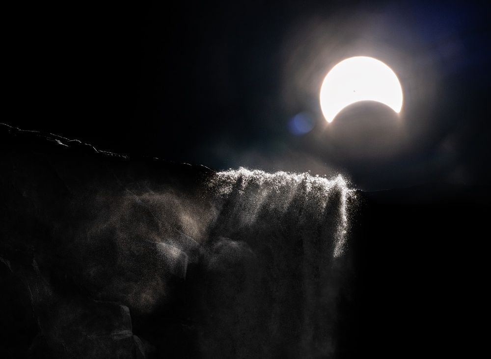 The 2024 solar eclipse rising over Bridalveil Fall in Yosemite Valley