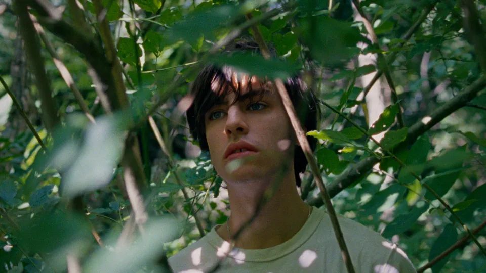 Still aus dem Film „Der Fleck“ von Willy Hans. Kinostart 10.7.
„Der 17-Jährige Simon ist als Letzter zu der Gruppe gestoßen, die diesen Sommertag am Fluss verbringt, mit Limonade, Kippen und Tuscheln unter dem aufgespannten Badetuch. Man mustert sich verstohlen und ist doch viel zu sehr mit sich selbst und seinem Körper beschäftigt, um den anderen wirklich wahrzunehmen.“