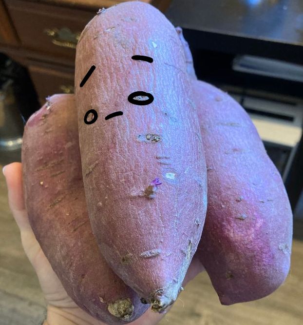 the same sweet potatoes as pictured but with certain eyes and notches in the top one outlined to make the shape of a face