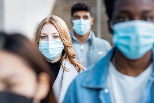 Photo of various people wearing the iconic pandemic facemask