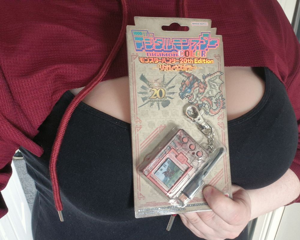 AJ holding a Monster Hunter VPet Digimon Colour 20th Edition