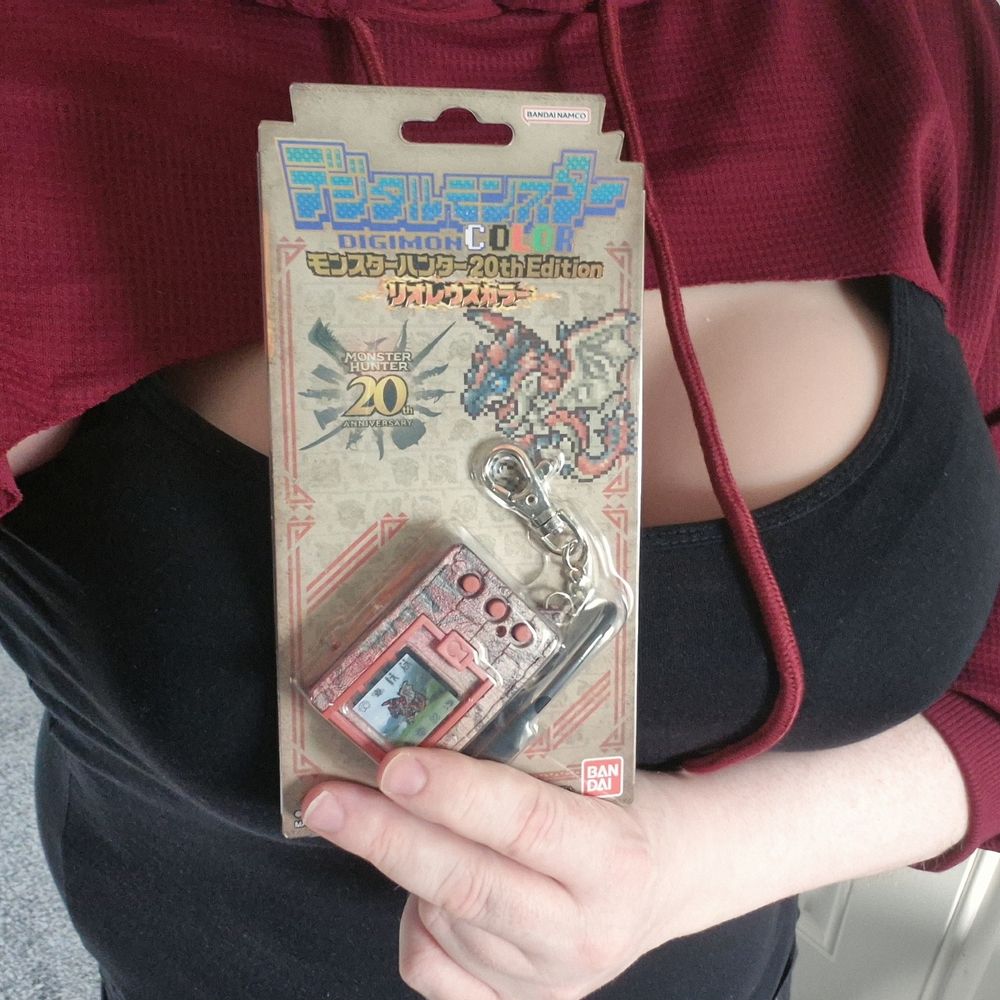 AJ holding a Monster Hunter VPet Digimon Colour 20th Edition