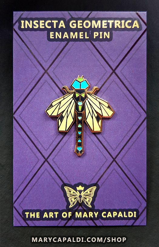 Enamel pin of a dragonfly designed completely with straight lines and geometric shapes. It's resting on a purple backing card that reads "Insecta Geometrica Enamel Pin" at the top and "The Art of Mary Capaldi" at the bottom with a crowned moth logo.
