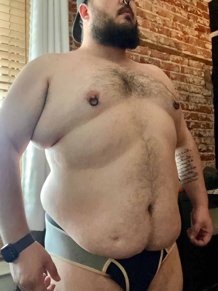 Me, a man, standing in front of the camera in only my underwear to show off my body.