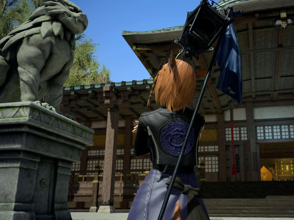 looking up at a liondog statue, facing away from the camera