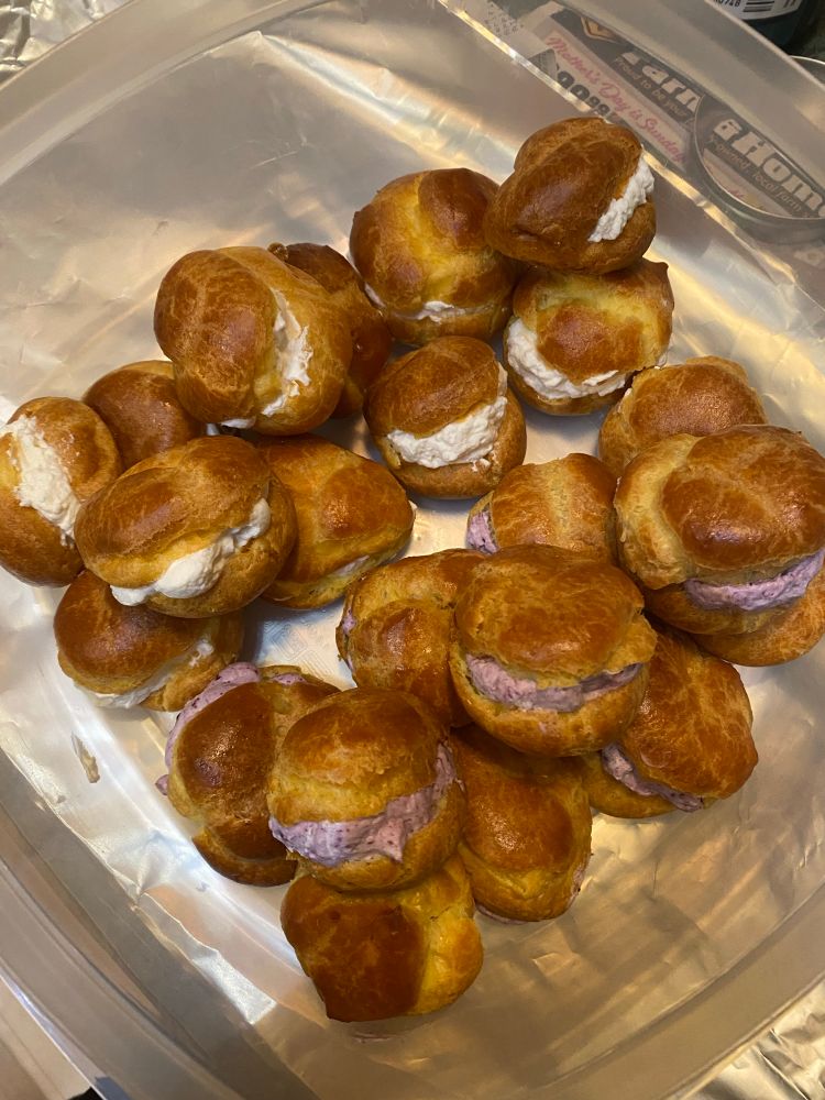 Cream puffs with vanilla whipped cream and blueberry vanilla whipped cream