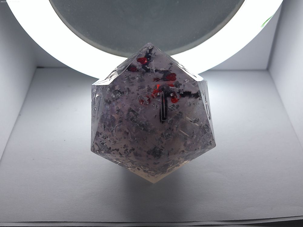 Faintly translucent purple CHONK die with silver flakes and sparkles