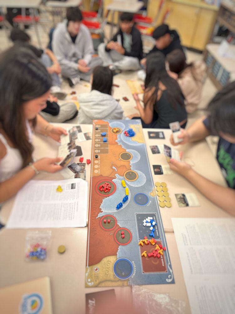 Picture of two students playing Shores of Tripoli board game. 