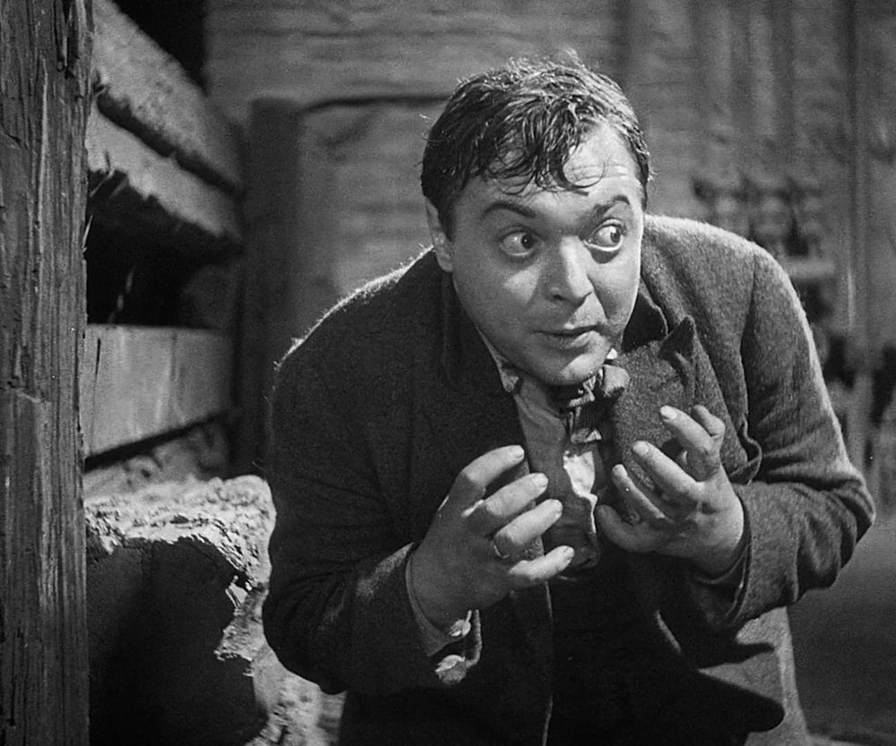 A scene from the crime noir film M. A man, played by a young Peter Lorre, hunches in the corner of a dank, industrial interior, clearly some sort of basement. His eyes are wild, his face and hands tight, his eyebrows as high as they can get. This is a man cornered, a man trapped. This is a man who has been caught, and who knows he deserves it.
