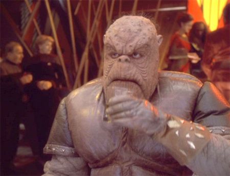 The “Morn” alien from Star Trek Deep Space 9. He was a lumpy alien who hung out at the bar, and was obviously named after Norm on Cheers. 