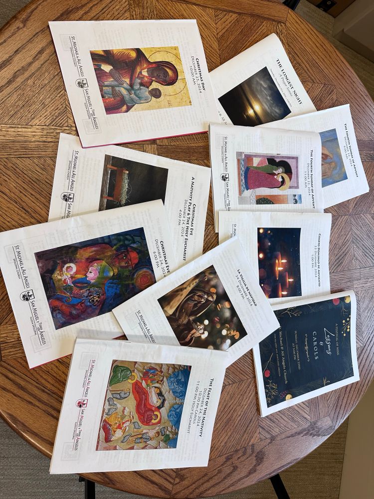 A table holds ten leaflets for different religious services in the last week of Advent through Christmas Day. 