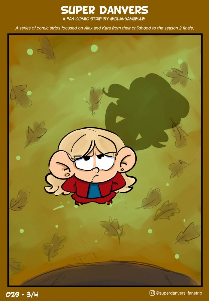 Kara is in a forest, arms in a Supergirl pose and looking up with determination. She means serious business.