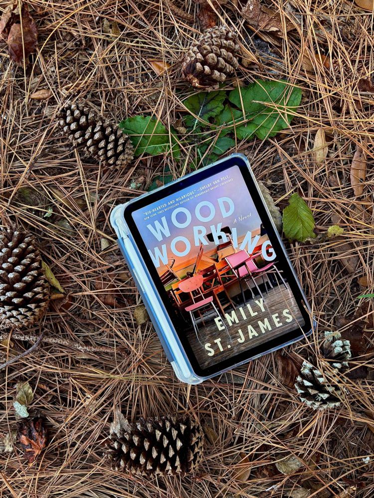 Woodworking by Emily St. James on a bed of thistle, pinecones, and leaves.