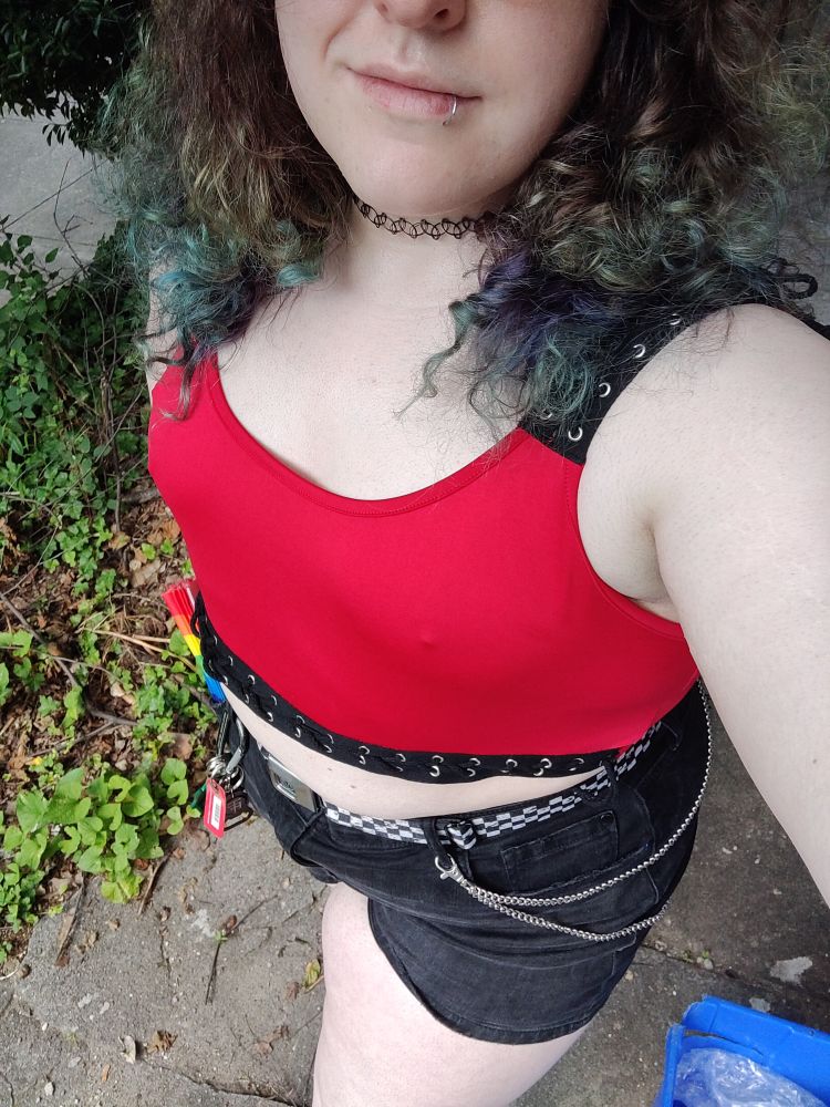 me wearing a red bralette and black denim short shorts with a carabiner and wallet chain