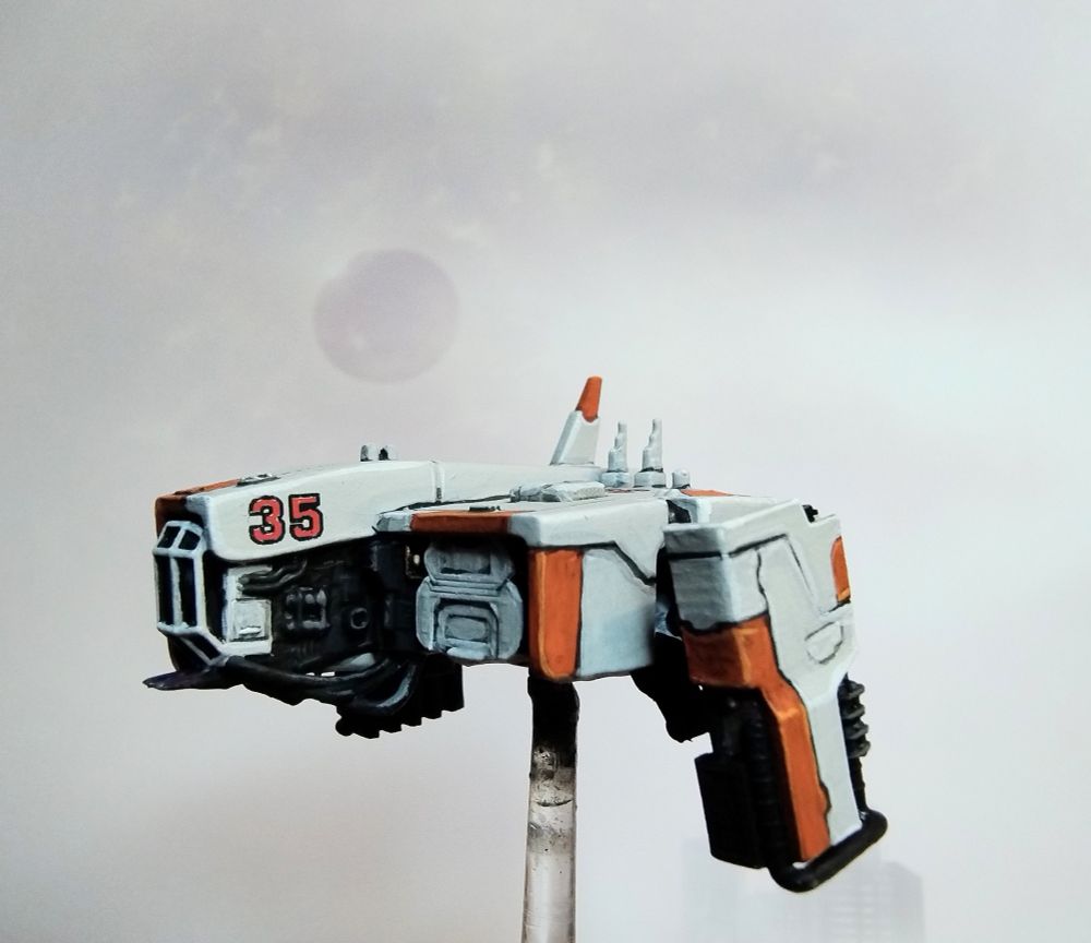 1:300 scale model of a sci-fi dropship painted in white with orange accents.